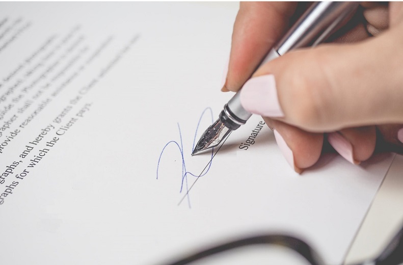 A fountain pen signs a document
